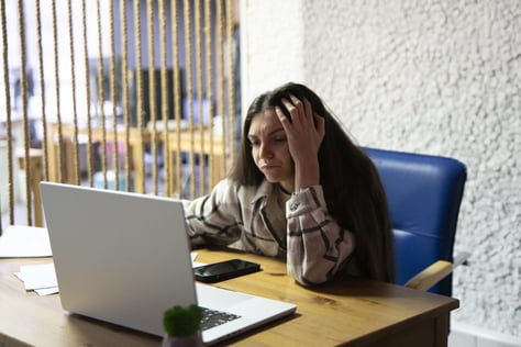 exhausted-office-worker-sitting-at-her-desk-late-a-2025-01-26-23-41-49-utc