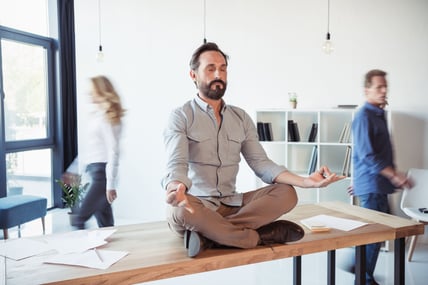 relaxed-businessman-meditating-in-lotus-position-w-2024-11-17-10-20-43-utc-1