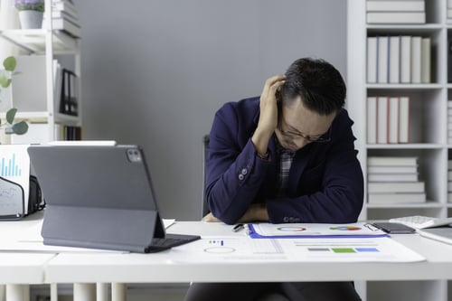 stressed-asian-businessman-having-headache-while-w-2025-03-09-01-11-46-utc