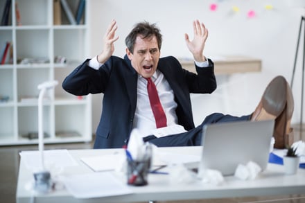 stressed-mature-businessman-sitting-at-table-with-2024-11-19-18-37-24-utc